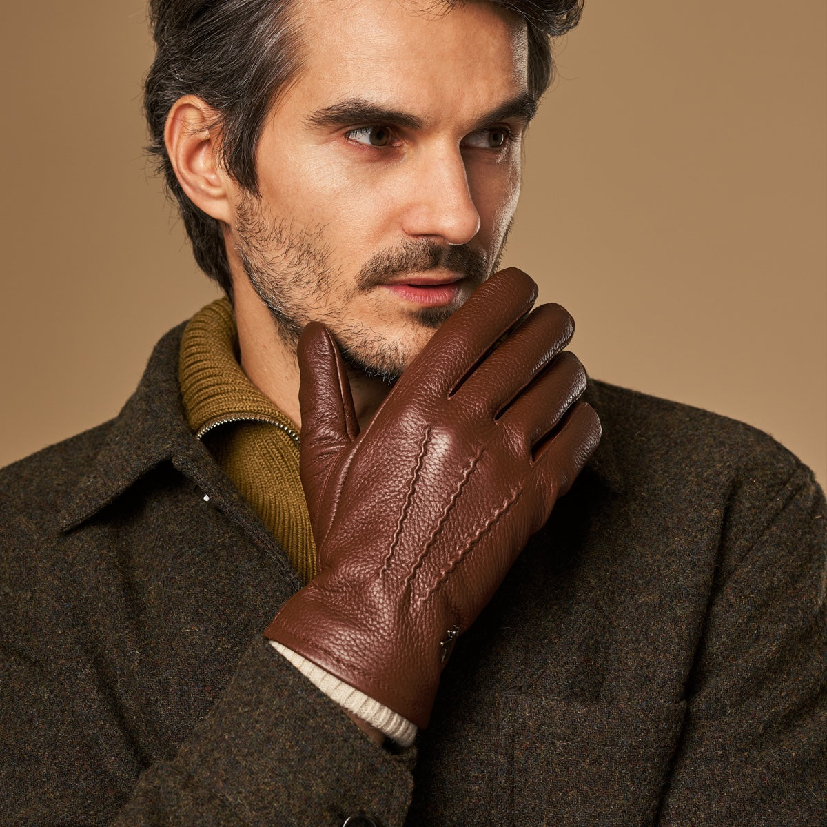 Brown leather gloves with cream knit lining and stitched palm panel detail