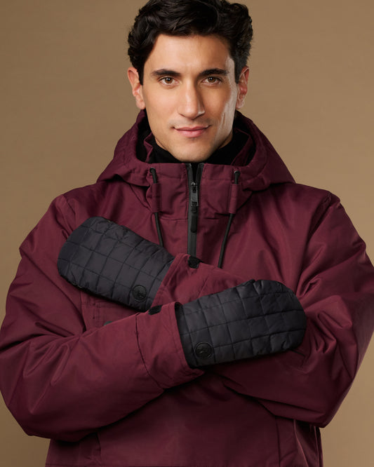 Black quilted waterproof mittens with long cuffs, modeled on crossed hands.