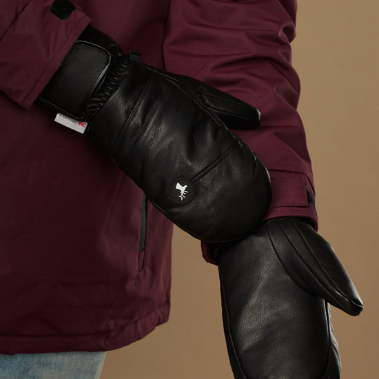 Pair of black leather men's mittens showing smooth palms, side seams, and cuff details.