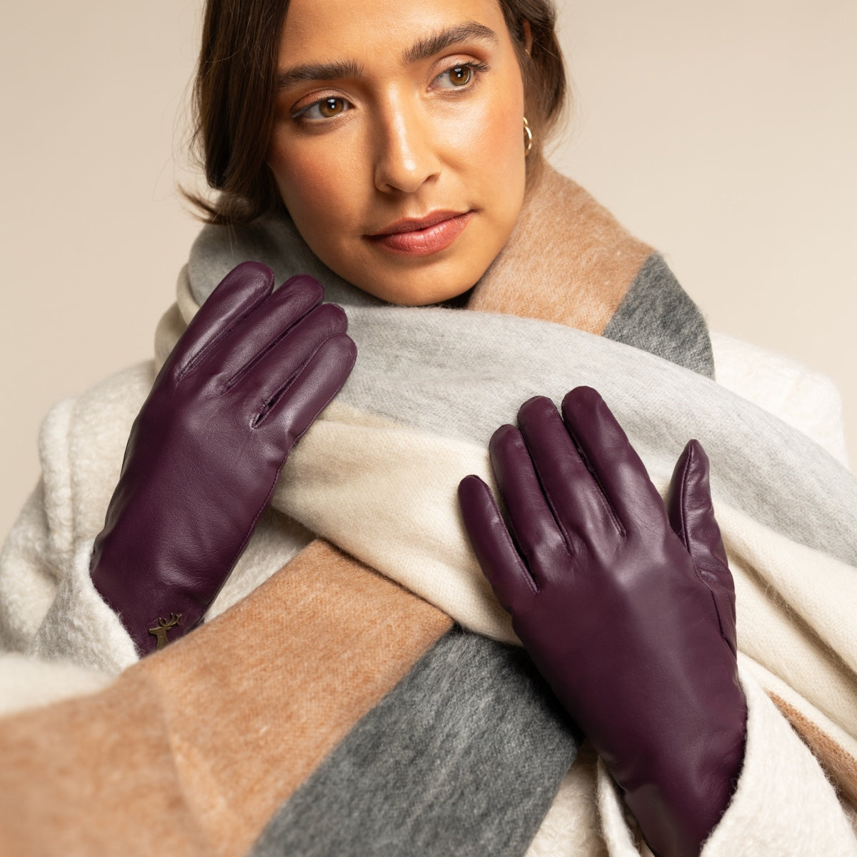 Pair of purple leather gloves with soft knit lining cuffs