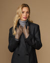 Women’s taupe leather gloves with snug fit, worn at chest level