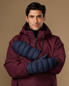 Blue insulated mittens worn with maroon winter jacket sleeves