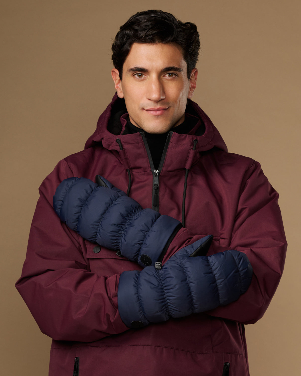 Blue insulated mittens worn with maroon winter jacket sleeves