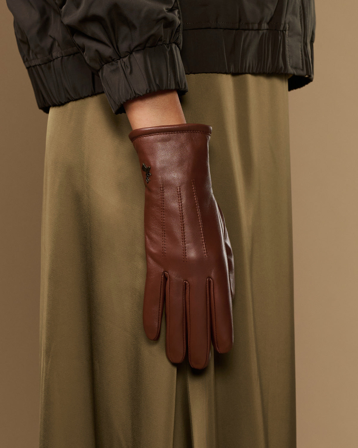 Single cognac brown leather glove with warm fleece lining and long cuff