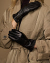 Black leather gloves showing side-zip detail and smooth palm finish