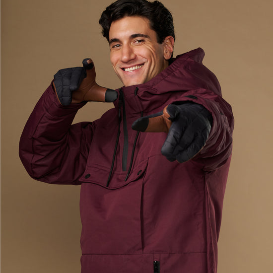 Men's quilted insulated touchscreen gloves, dark gray worn while smiling