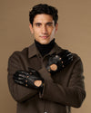 Men's black leather driving gloves with touchscreen fingers and elastic wrist cuffs