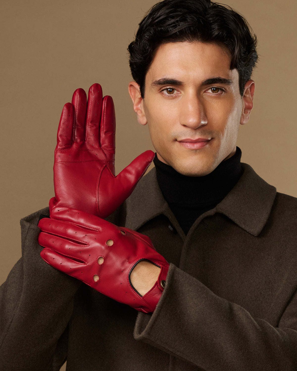 Men's red leather driving gloves with five-finger design and metal stud accents