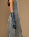 Women’s grey below-elbow leather glove on forearm with fitted fingers