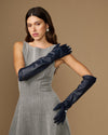 Women's blue leather elbow gloves shown on model, covering upper forearm
