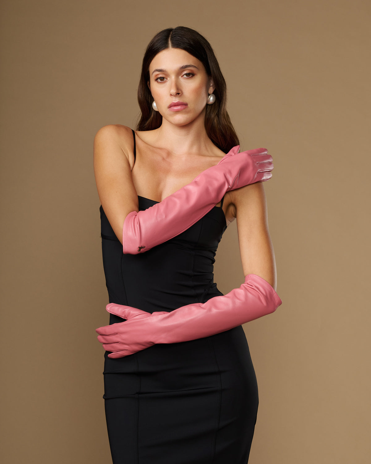 Pair of pink elbow-length leather gloves with smooth finish and long cuffs
