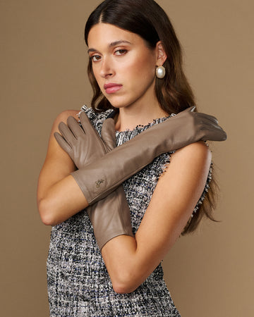 Taupe lambskin leather gloves, below-elbow length, smooth stitched fingers and slim cuff.