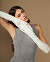 White elbow-length leather gloves with smooth palm and long cuff, worn in a pose
