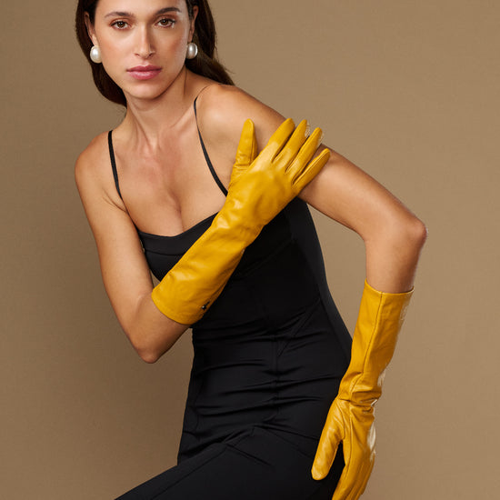 Yellow lambskin leather below-elbow gloves with smooth surface and neat cuff stitching