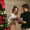 Women’s brown elbow-length leather gloves worn while holding a gift box.