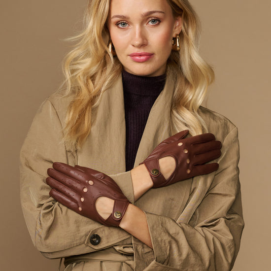 Brown leather driving gloves with elastic wrist and perforated knuckle details
