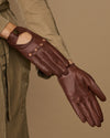 Brown leather driving gloves with stitched finger seams and perforated knuckle lines